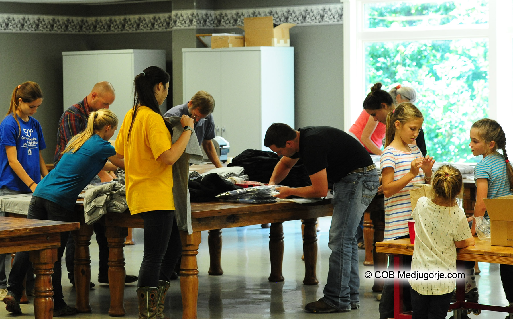 Caritas Community packing This is My Time t-shirts